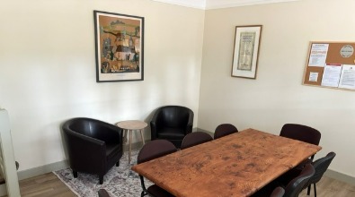 Meeting table and leather tub chairs in the refurbished Library Room